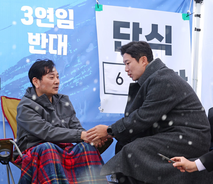 국민의힘 진종오 의원이 지난 27일 이기흥 현 대한체육회장의 3선 도전을 비판하며 서울 송파구 대한체육회 앞에서 단식투쟁 중인 박창범 전 우슈협회장을 찾아 대화를 나누고 있다.