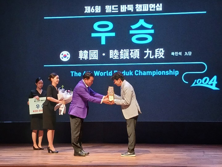 김대인 신안군 부군수가 목진석 9단에게 우승 트로피를 전하고 있다.(신안에서 MHN 엄민용 선임기자)