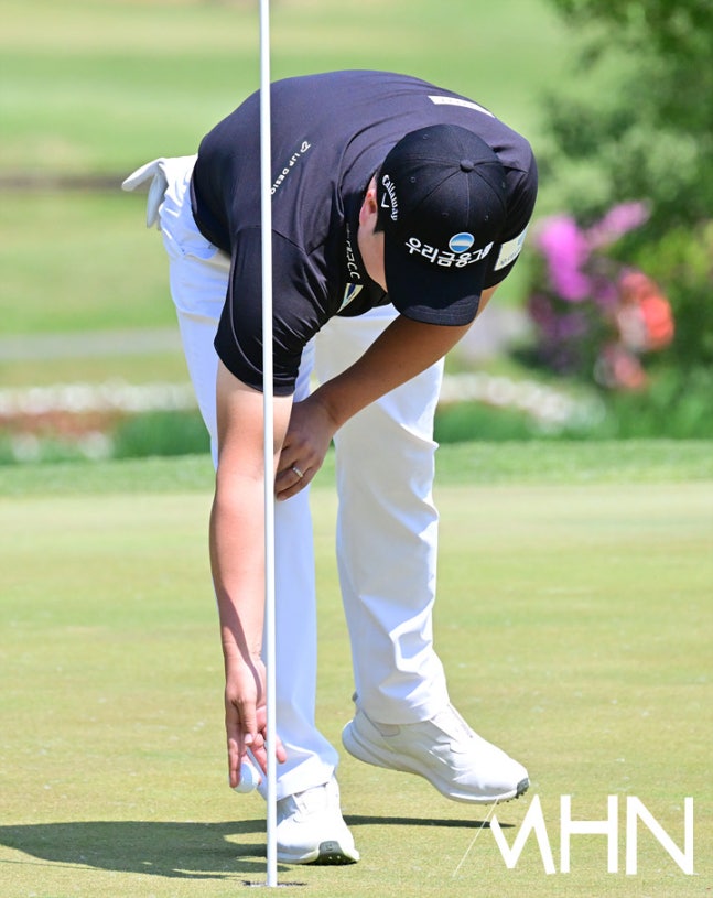 황중곤이 25일 열린 KPGA 투어 우리금융 챔피언십 3라운드에서 생애 첫 홀인원을 잡아낸 후 홀에서 볼을 집어 올리고 있다.